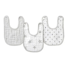 Three Aden + Anais Snap Bibs in dusty tones, featuring patterns of stars and polka dots, designed for baby use.