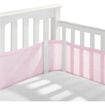 BreathableBaby classic breathable mesh crib liner in light pink installed in a white crib, enhancing safety and airflow.