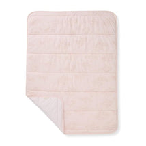 Reversible pink blanket featuring a subtle ranunculus floral pattern with a striped underside.