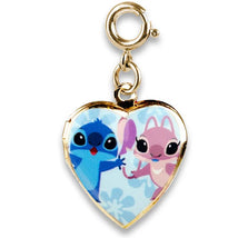 Gold heart-shaped locket charm featuring cartoon characters, a blue character and a pink character, on a light blue background.
