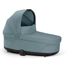 Cybex Balios Cot S Lux in Stormy Blue, featuring a soft fabric exterior, a protective canopy, and a sleek design.