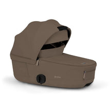Cybex Mios/Coya Fold Lux Carry Cot in Coconut Brown, featuring a soft canopy and sleek design, ideal for infant transport.
