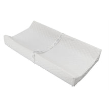 Contoured changing pad in white with a quilted surface, designed for comfortable diaper changes.
