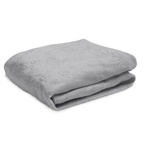Grey plush changing pad cover, contoured shape with subtle embossed patterns, designed for comfort during diaper changes.