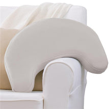 Light gray Dr. Brown Feeding & Nursing Lap Support Pillow resting on a couch, designed for comfort during feeding.