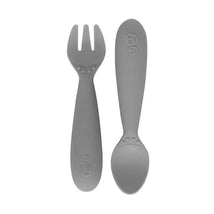 Mini utensils set in pewter color, featuring a fork and a spoon designed for easy handling by small hands.