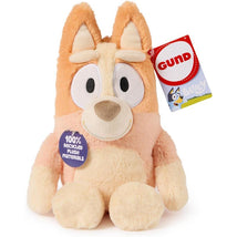 Bingo plush toy with orange and cream fur, large eyes, and a tag indicating 100% recycled materials.
