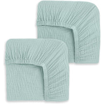 Fitted crib sheets set of two in a calm sage color, showcasing soft, textured fabric and elastic edges for secure fit.