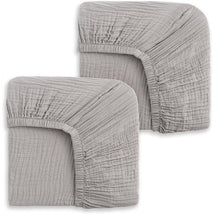 Two storm grey fitted crib sheets, showcasing a soft, textured fabric with elastic edges for secure fit.
