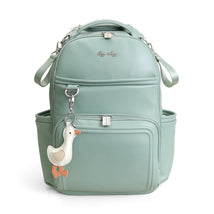 Light green Itzy Ritzy Boss Plus™ Backpack Diaper Bag with a duck-shaped keychain attached, featuring multiple compartments.