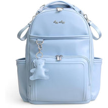 Large blue diaper bag backpack features multiple compartments and a teddy bear keychain for easy access and style.