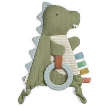 Green dinosaur-shaped sensory toy with textured teether ring and colorful tag ribbons for tactile stimulation.