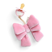 Itzy Ritzy Bitzy Pal Pacifier & Lovey Set featuring a soft pink velvet bow and a yellow rubber pacifier attached by a cord.
