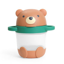 Itzy Ritzy Itzy Snack Pal in bear design, featuring a brown bear lid and a clear container with green handles.