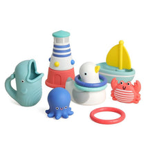 A colorful set of nautical-themed bath toys including a whale, octopus, lighthouse, duck, sailboat, crab, and a ring.