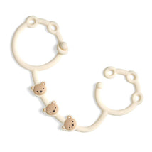 Toy and snack cup strap featuring a soft beige color with three cute bear faces for attaching items securely.