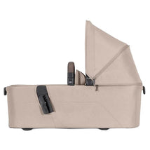 Foldable Joolz Aer bassinet in sandy taupe with a sleek design and adjustable canopy, featuring secure fastening mechanisms.