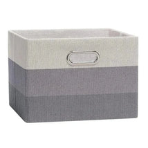 Foldable storage bin in gray ombre with a silver handle, ideal for organizing and decor.