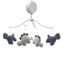 Musical mobile featuring plush dinosaur figures in gray and navy, suspended from a white overhead frame.