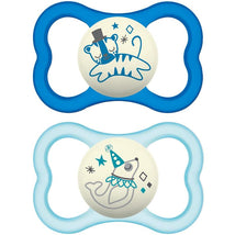Two Mam air night pacifiers for boys, featuring a blue tiger design and a light blue whale design, suitable for ages 16 months and up.