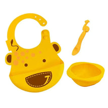 Yellow baby feeding set, featuring a bib with a cheerful giraffe design, a matching bowl, and a small spoon.