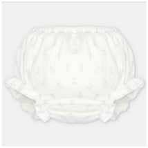 Baby girl bloomer made of woven fabric in white with light blue floral patterns and ruffled edges.