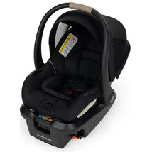 Maxi-Cosi Mico Pro+ infant car seat in Sea Shadow color, featuring a black fabric with safety labels and a carrying handle.