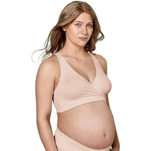 Maternity sleep bra in chai color on a pregnant woman with long hair, featuring a comfortable wrap design for support.