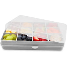 Grey divided snack container with 12 compartments, filled with various fruits like grapes, blueberries, and strawberries.