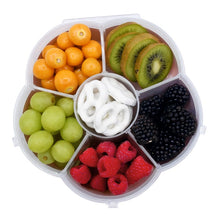 Snackable box featuring assorted fruits including grapes, raspberries, kiwis, and pretzels, arranged in a six-compartment design.