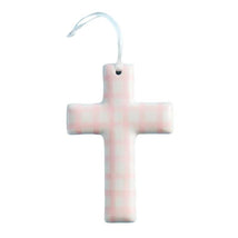 Pink checkerboard ceramic cross with a hanging loop, designed for decorative purposes.