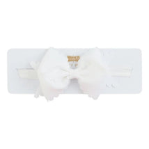 White scallop bow headband by Mud Pie displayed on a white card, featuring a satin band and decorative bow detail.