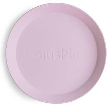 Soft lilac silicone round plate from Mushie, featuring a smooth surface and an embossed brand name.