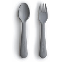 Mushie silicone fork and spoon set in smoke color, designed for children, featuring smooth rounded edges.