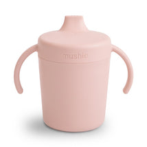 Mushie Trainer Sippy Cup in blush color with two handles, designed for toddlers to encourage independent drinking.