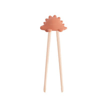 Mushie Training Chopsticks in rose color, featuring a playful dinosaur-shaped top for children learning to use chopsticks.