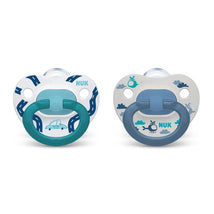 Two assorted Nuk pacifiers featuring a car design on a white background and a helicopter design on a gray background.