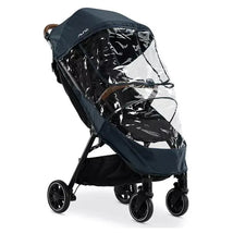 Nuna TRVL™ Series Rain Cover attached to a stroller, featuring a clear plastic front and navy fabric canopy.