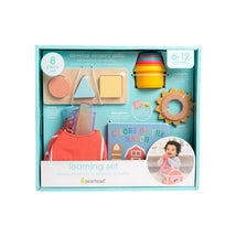 Montessori developmental toy set by Pearhead for 6–12 months, including colorful shapes, a book, and an activity bag.