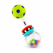 Sassy Spin Shine Rattle with a green dotted ball, colorful rings, and clear sphere containing multicolored balls inside.