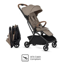 Compact travel stroller in Champagne color, featuring a foldable design and IATA Cabin Compliant logo.