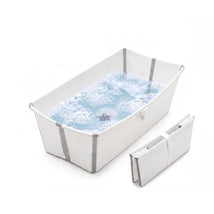 Stokke Flexi Bath X-Large in White Grey, featuring water with bubbles and a foldable design next to it.
