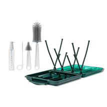 Travel Cleaning Kit & Drying Rack featuring brushes, a spray bottle, and a two-part drying rack in green and white.