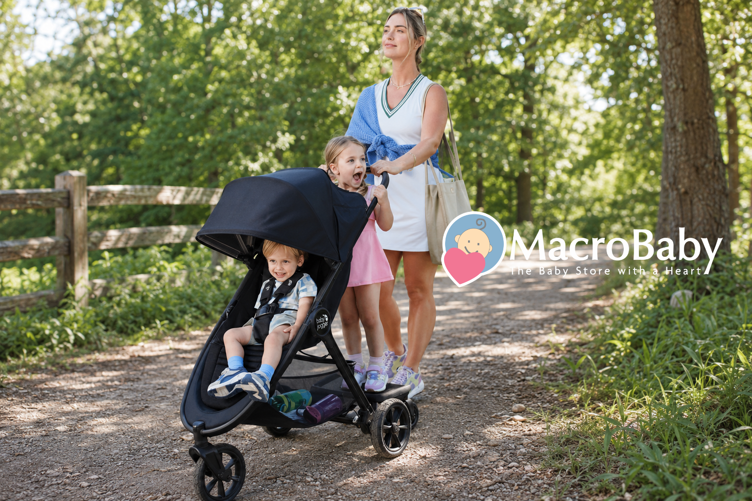 Family walking with an all-terrain stroller on a forest trail.