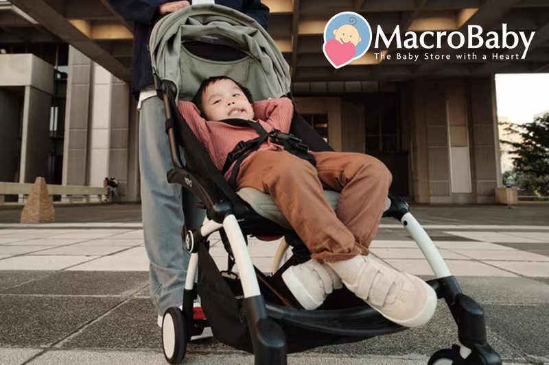 Happy toddler in lightweight stroller outdoors, perfect for urban walks and baby travel essentials