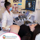Pregnant woman receiving 4D ultrasound scan with technician in medical setting