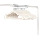 Cream velvet baby hangers, 15-pack, displayed on a white rack, featuring a soft texture and curved design.