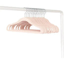 15 pink baby velvet hangers with chrome hooks hanging on a white rod.