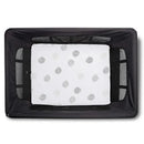 White bassinet sheet with a grey dotted pattern, fitted inside a black mesh-sided bassinet.