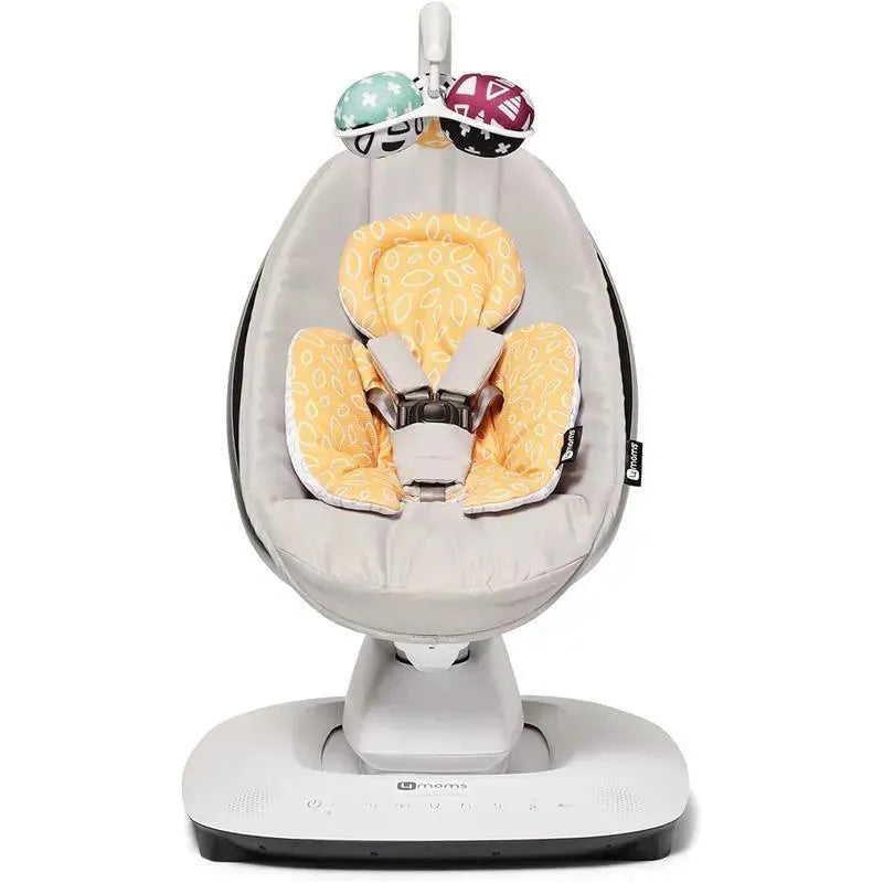 Reversible newborn insert in yellow for 4 Moms baby seat, featuring soft fabric and safety harness.